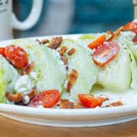 The Wedge · Iceberg wedge, crumbled blue cheese, bacon, cherry tomatoes and blue cheese drizzle.
