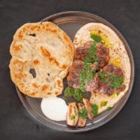 Lamb Kofta Kebabs · Hummus, pine nuts, shallots, parsley-coriander salsa.