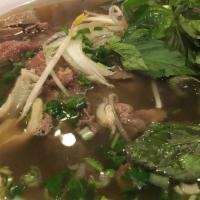 Combination Pho / Phi Dac Biet · Noodle soup with thin sliced top rounds, well done beef tendons, meatballs, and tripe.