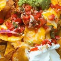 Nachos · Melted cheddar and jack cheeses, pico de gallo, sour cream and guacamole.. You can add chick...