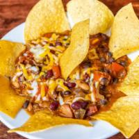 Chili · Steak, chicken andouille sausage with a blend of beans topped with cheese and served with na...