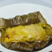 Tamal  Colombiano · Colombian tamales  all wrapped on banana leaves corn dough with carrot, peas, potatoes, piec...