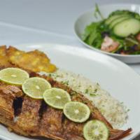 Whole Fried Tilapia · Whole fish fried and seasoned. Served with rice, green plantain and salad
