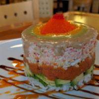 Dc Monument Roll · Masagi, stacked crab, lump crab, spicy tuna, avocado, with chef's special sauce on sushi rice.