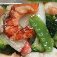 Seafood Combination · Lobster meat, crabmeat jumbo shrimp and scallops with many  kinds of fresh vegetable in tast...