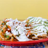 Loaded Nachos  · Topped with melted cheese, beans, guacamole, pico de gallo and sour cream.