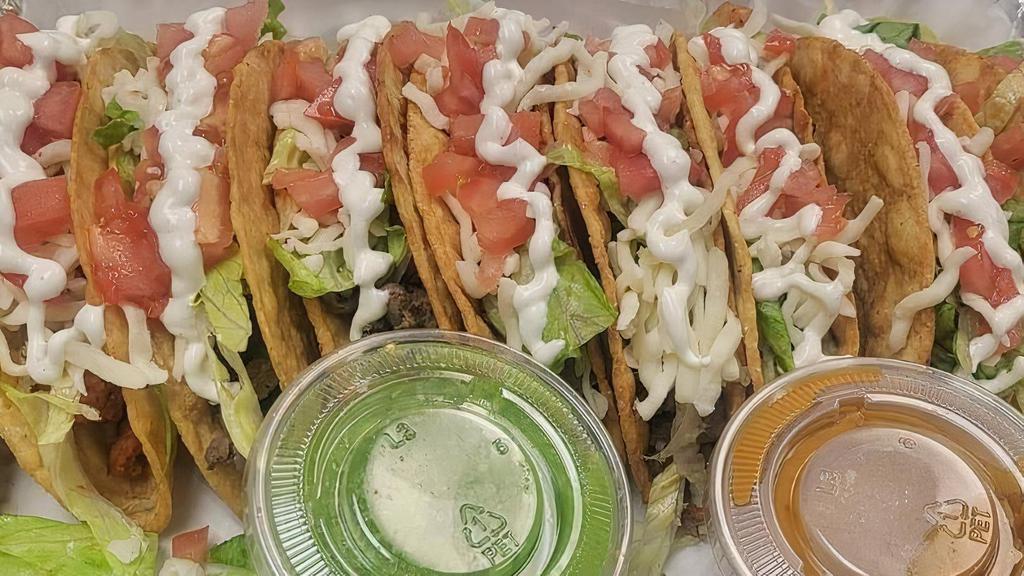 Order Hard Tacos · Served with a crunchy tortilla filled with the protein of your choice, lettuce, tomato, crema, and cheese.