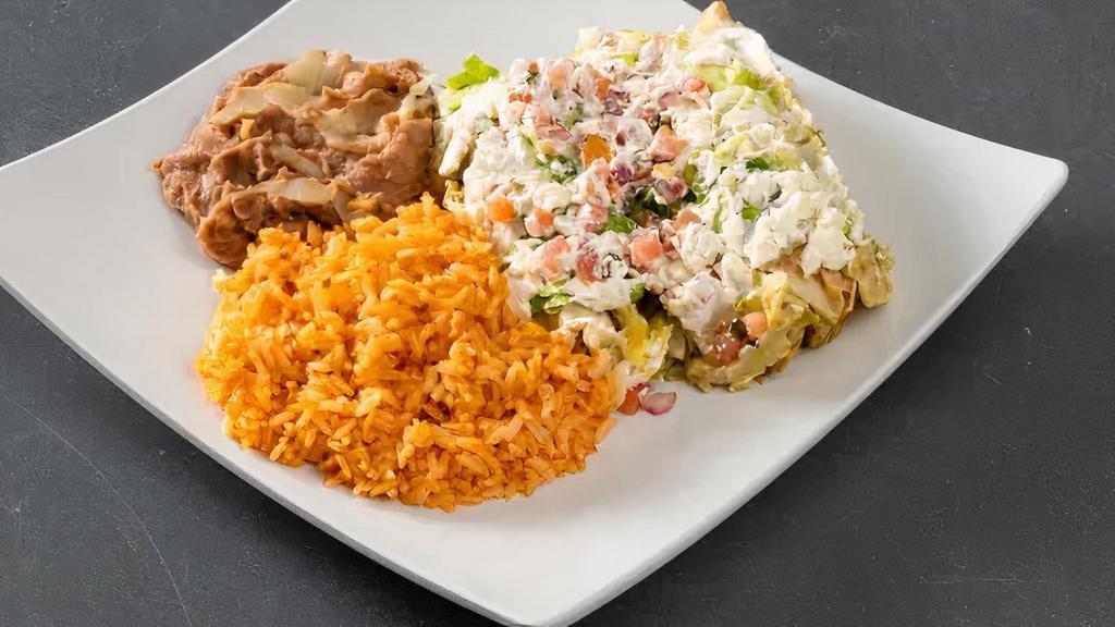 Enchilada · Three corn tortillas, choice of one filling, salsa verde, topped with melted cheese. Side of rice, refried beans, lettuce, pico, sour cream.