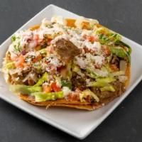 Tostada · Toasted corn tortilla, choice of one filling, refried beans, pico, lettuce queso fresco, cre...