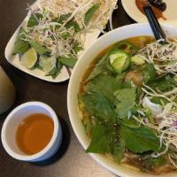 Bun Bo Hue / Spicy Hue Beef Noodle · Served with bean sprout, lettuce, jalapeños and lime.