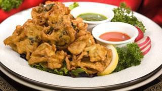 Pakora · All natural spiced mixed fritters made in chickpea flour served with tamarind and green chut...