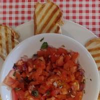 Bruschette · Fresh Garlic, fresh tomato, fresh basil and onions in olive oil.