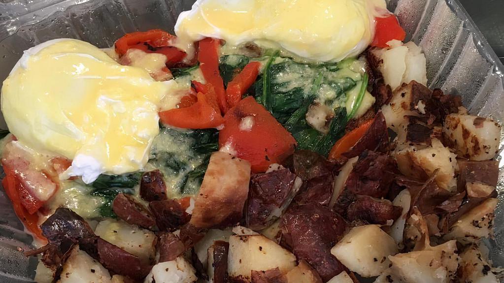 Crab Cake Benedict · Tom's homemade crab cakes topped with sautéed baby spinach, roasted red peppers and two poached eggs topped with our homemade hollandaise sauce.