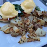 California Benedict · Toasted English muffin topped with avocado, sautéed baby spinach, tomato, two poached eggs, ...