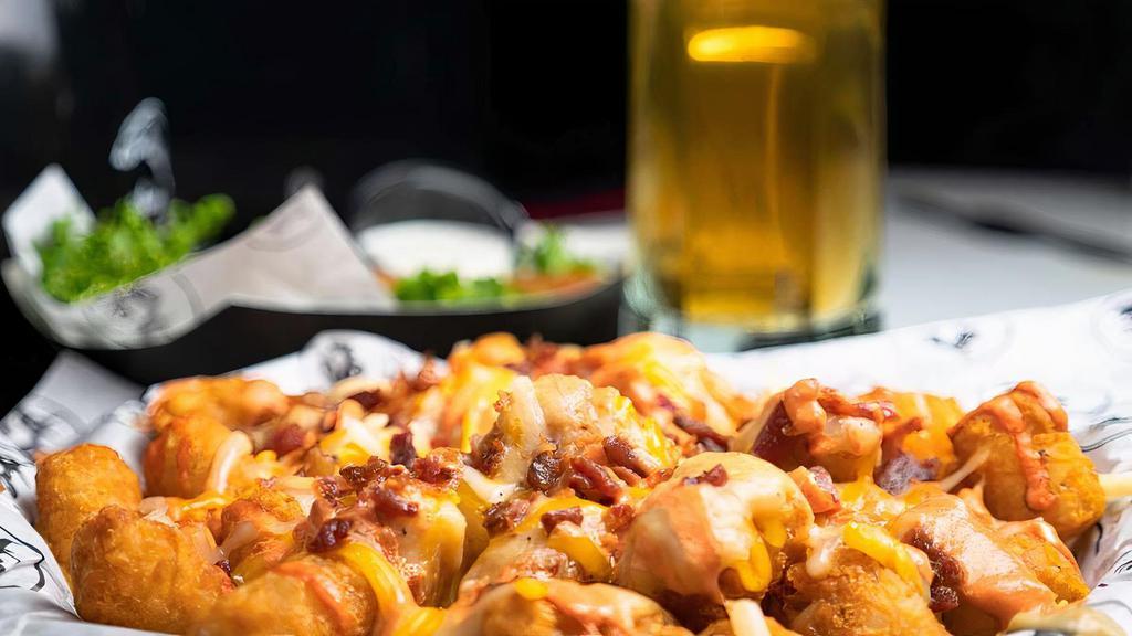 Chili & Cheese Tots · Tater tots topped with chili & cheese.