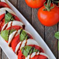 Caprese Salad · Fresh mozzarella and sliced tomatoes, drizzled with EVOO and balsamic glaze.