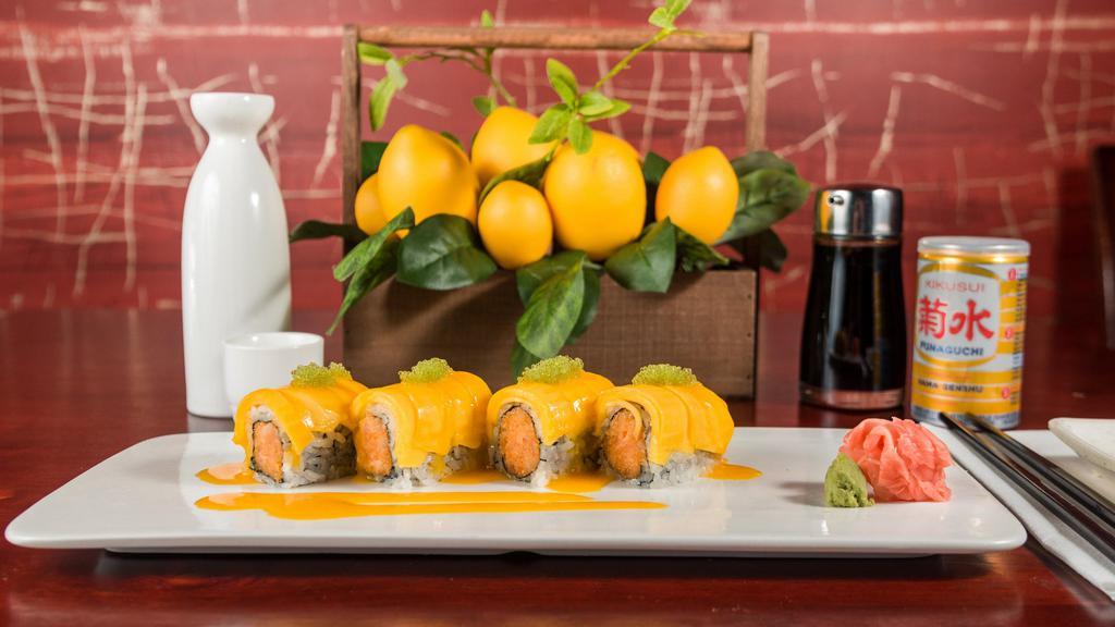 Mango Dancing Roll · Spicy white tuna and tempura flake inside, topped with spicy yellowtail, fresh mango and tobiko.