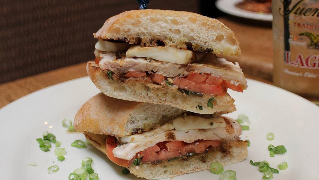 Chicken Caprese Sandwich · Fresh mozzarella, basil, and tomato pressed on ciabatta. Served with choice of side.
