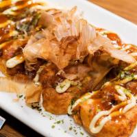 Takoyaki · Pan fried flour based octopus balls filled with minced octopus, cabbage, drizzled in house s...