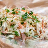 Cabbage Slaw · Green cabbage, carrots, red onions, mayo, and apple cider vinegar.