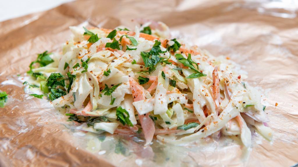 Cabbage Slaw · Green cabbage, carrots, red onions, mayo, and apple cider vinegar.