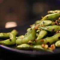 Spicy Edamame · Hot and spicy. Boiled soy beans stir fried in garlic chili.