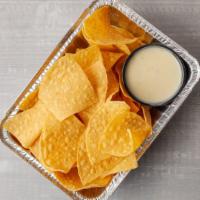 Chips & Queso · Melted cheese dip and chips.