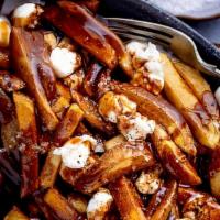 Poutine · French fries covered with short rib, demi-glace, and garlic cheese curds.