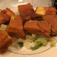 Paneer Pakora (4) · Homemade cottage cheese marinated in chickpea batter and deep fried.