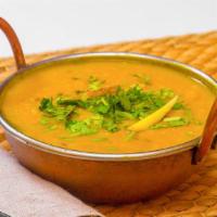 Tarka Daal · Puree yellow lentil gently tempered with fresh herbs and seasonings.