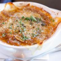 French Onion Soup · Classic homemade onion soup topped with croutons and Austrian Gruyere cheese