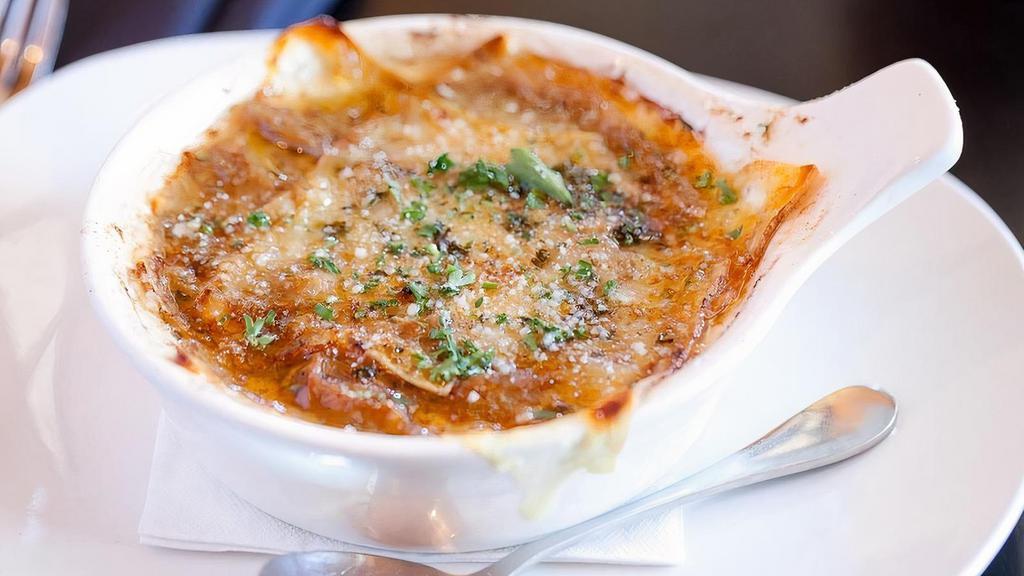French Onion Soup · Classic homemade onion soup topped with croutons and Austrian Gruyere cheese