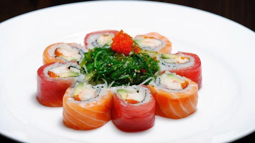 Season Maki · Spicy lobster with avocado and cucumber topped with salmon, tuna, and garnish with seaweed salad.