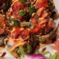 New Volcano Maki · Deep-fried spicy crunch salmon with avocado, kani, and seaweed out side topped with spicy cr...