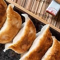 Dumpling (7) · Steamed or fried, stuffed with pork and vegetables, served with ginger sauce.