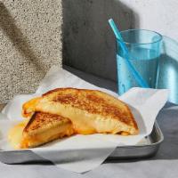 Grown Up Grilled Cheese · Melted cheddar, swiss, and jack cheese between two slices of buttery grilled bread.