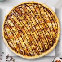 On The Grill Bbq Chicken Pizza · White pizza, chicken, red onion, bacon, and BBQ sauce baked on a hand-tossed dough.