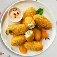Jalapeno Poppers · Fresh jalapenos coated in cream cheese and fried until golden brown.