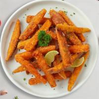 Sweet Potato Fries · Shredded sweet potatoes formed into tots, battered, and fried until golden brown.