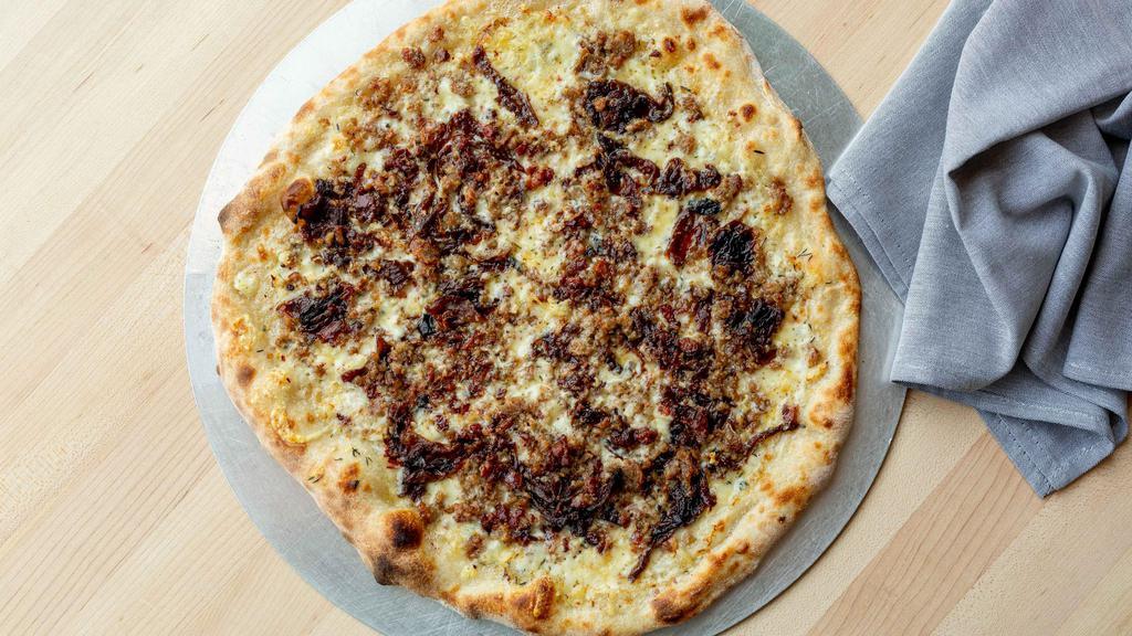 12″ Small Alsatian Pie Pizza · Gruyere cheese, fromage blanc caramelized onion, Italian sausage and bacon, thyme. BEST SELLER!