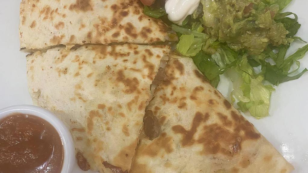 Quesadillas · Grilled tortillas filled with melted cheese. Served with salsa, pico de gallo and sour cream.