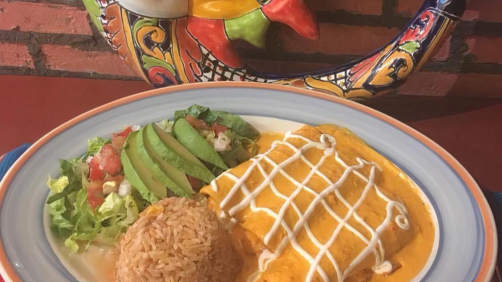 Enchilada · Soft folded corn tortillas stuffed with your choice of cheese, shredded chicken or beef, topped with our hot or mild sauce, sour cream and Mexican cheese.