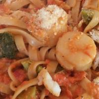 Fettuccini & Grilled Shrimp · Shrimp, tomato, mushrooms, spinach, capers, sundried tomato, garlic, and spices.