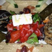 Mediterranean Combo · Hummus, Baba Ghanouj, roasted pepper, grilled portabella mushroom and eggplant over greens w...