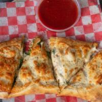 Chicken Broccoli And Cheese Calzone · Made with ricotta cheese and served with marinara sauce on the side.