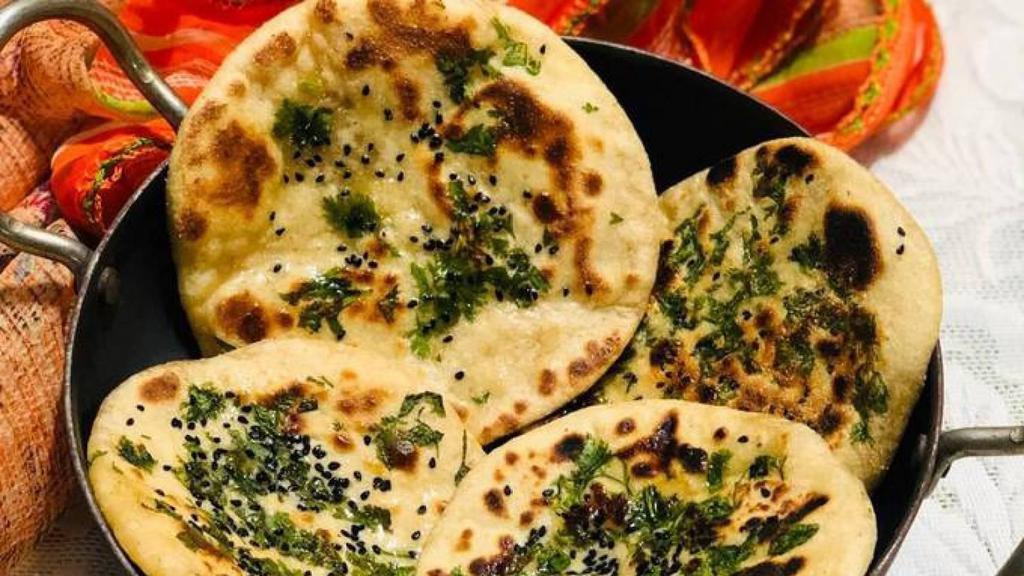 Paneer Stuffed Naan · Traditional Indian flatbread stuffed with freshly grated paneer (Indian cheese), coriander, onion, cumin and spices.