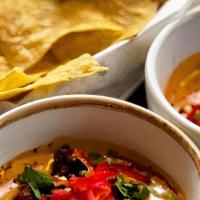 House-Made Chips & Queso · house-made corn tortilla chips with warm queso dip. gluten free and vegetarian.