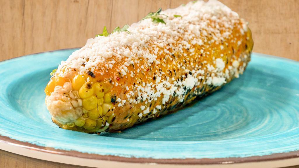 Street Corn (Elote) · Grilled corn on the cob brushed with chipotle mayo and topped with cotija cheese.