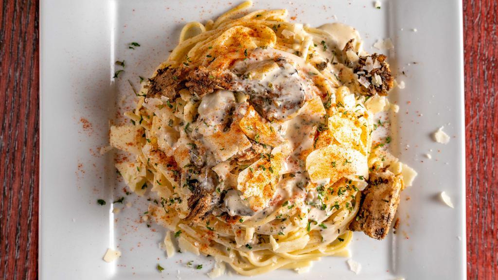 Jerk Chicken Alfredo  · Tender Chicken breast marinated in jerk sauce served on a bed of Linguine noodles covered in a spicy creamy Alfredo sauce