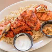 Chicken Tikka Kabob · Flame grilled skewers of boneless marinated chicken cubes. Served with rice and salad.